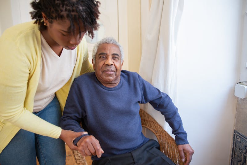 Volunteer visiting an elderly person at home